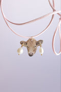 A cow with a piercing on a strap