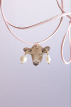 A cow with a piercing on a strap